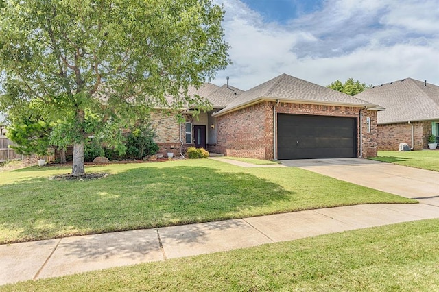 17425 White Hawk Dr, Edmond, OK 73012 - view of front of property featuring an attached garage, a front yard, concrete driveway, roof with shingles, and brick siding