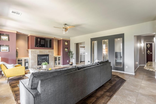17425 White Hawk Dr, Edmond, OK 73012 - living room with a fireplace, ceiling fan, and tile patterned flooring