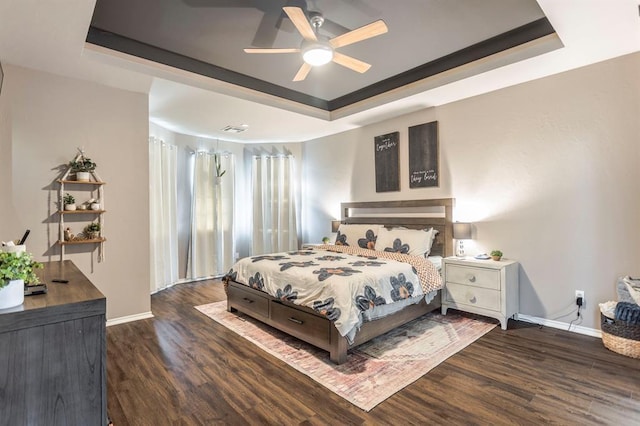 17425 White Hawk Dr, Edmond, OK 73012 - bedroom featuring a raised ceiling, wood finished floors, and a ceiling fan