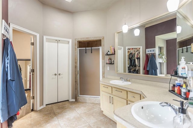 17425 White Hawk Dr, Edmond, OK 73012 - full bathroom featuring vanity, a shower stall, tile patterned flooring, and a walk in closet