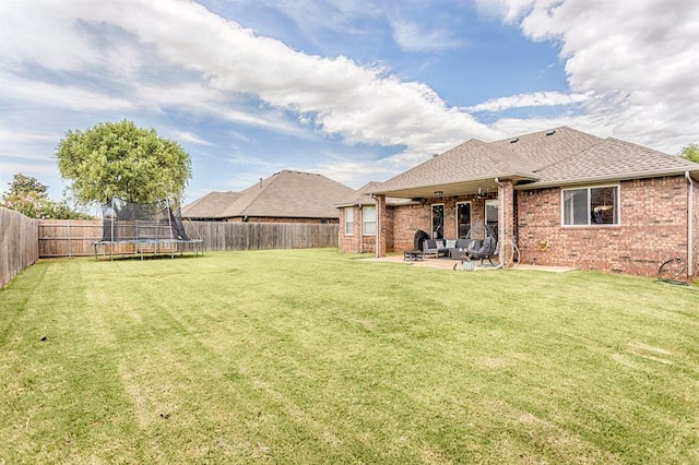 17425 White Hawk Dr, Edmond, OK 73012 - fenced backyard featuring outdoor lounge area, a trampoline, and a patio