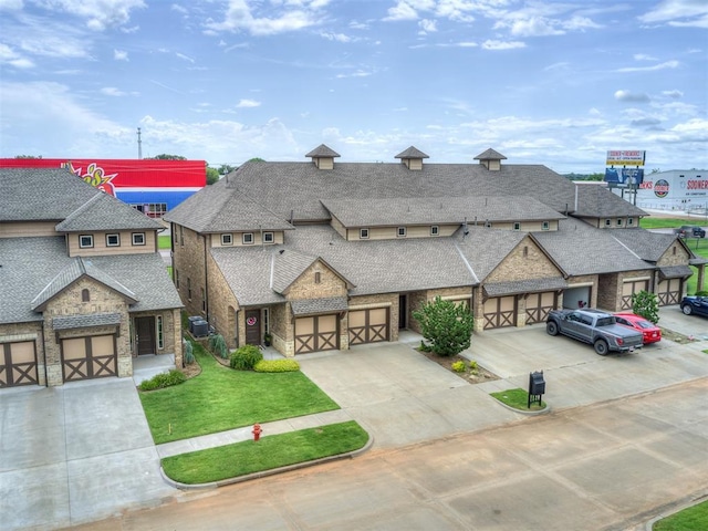 4800 Stelens Ct, Norman, OK 73071 - multi unit property with stone siding, roof with shingles, driveway, and a front yard