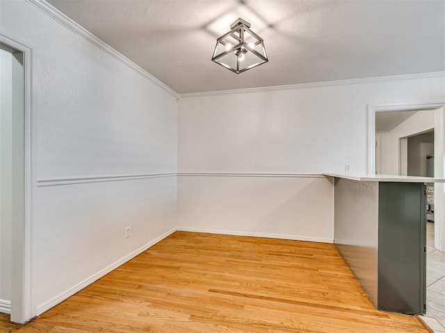 500 Dakota St, Norman, OK 73069 - unfurnished dining area featuring ornamental molding and light wood finished floors