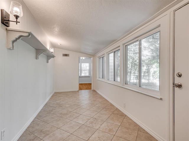 500 Dakota St, Norman, OK 73069 - unfurnished room featuring a textured ceiling, light tile patterned floors, and lofted ceiling