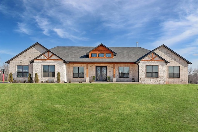 8960 N Banner Rd, Yukon, OK 73099 - view of front of home with stone siding, a front yard, roof with shingles, and french doors