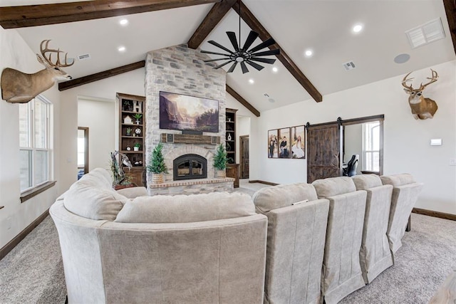 8960 N Banner Rd, Yukon, OK 73099 - carpeted living room featuring a barn door, a fireplace, ceiling fan, and recessed lighting