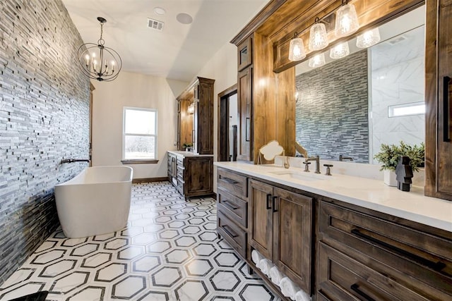 8960 N Banner Rd, Yukon, OK 73099 - full bathroom with two vanities, a freestanding tub, and a chandelier