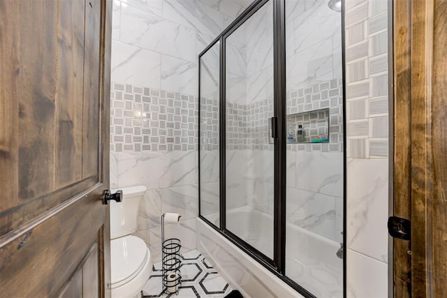 8960 N Banner Rd, Yukon, OK 73099 - bathroom featuring tile walls and bath / shower combo with glass door