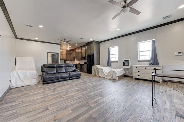 8960 N Banner Rd, Yukon, OK 73099 - living room featuring a ceiling fan, crown molding, light wood-style floors, heating unit, and recessed lighting