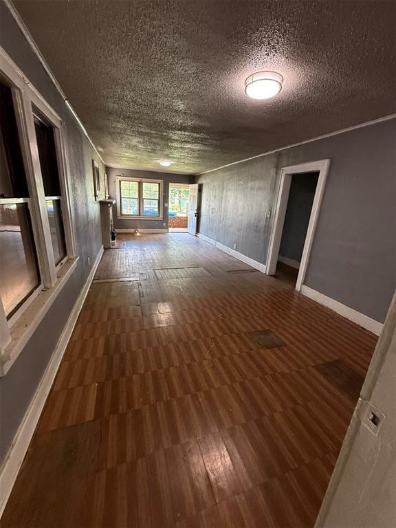 2338 NW 21st St, Oklahoma City, OK 73107 - spare room featuring a textured ceiling, dark wood-type flooring, and crown molding