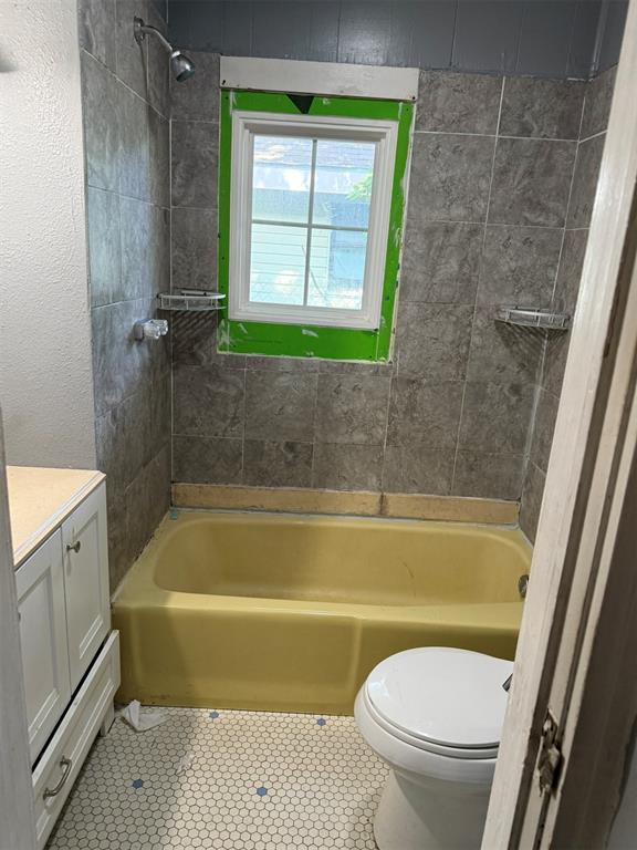 2338 NW 21st St, Oklahoma City, OK 73107 - bathroom featuring vanity, bathtub / shower combination, and tile patterned flooring