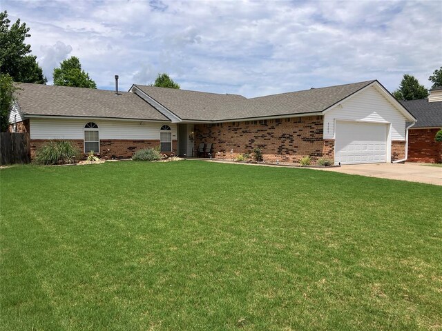9105 Oak Creek Dr, Midwest City, OK 73130 - ranch-style house featuring brick siding, concrete driveway, an attached garage, and a front lawn