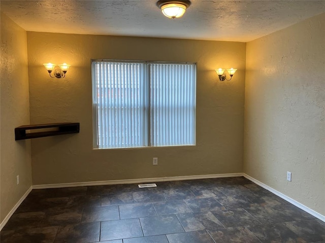9105 Oak Creek Dr, Midwest City, OK 73130 - empty room featuring a textured wall and a textured ceiling