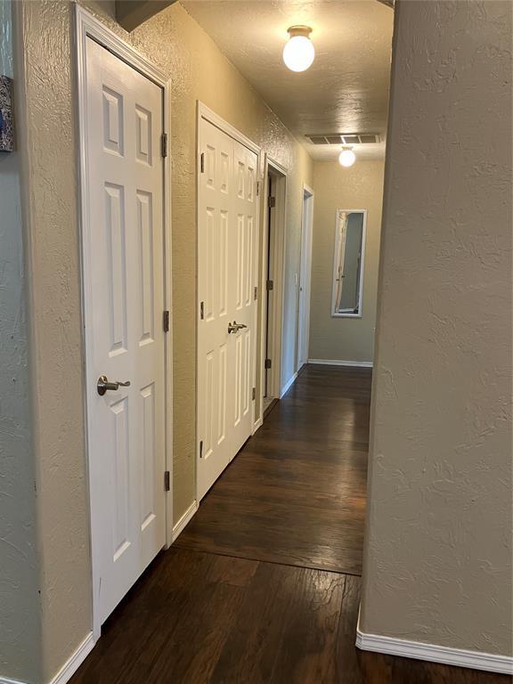 9105 Oak Creek Dr, Midwest City, OK 73130 - hall with a textured wall and hardwood / wood-style flooring