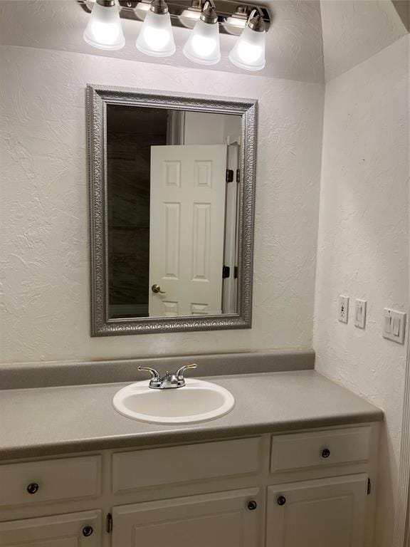 9105 Oak Creek Dr, Midwest City, OK 73130 - bathroom featuring vanity and a textured wall