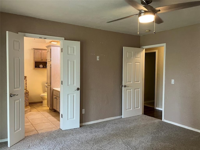 9105 Oak Creek Dr, Midwest City, OK 73130 - unfurnished bedroom with light carpet, ensuite bath, light tile patterned flooring, ceiling fan, and a textured wall