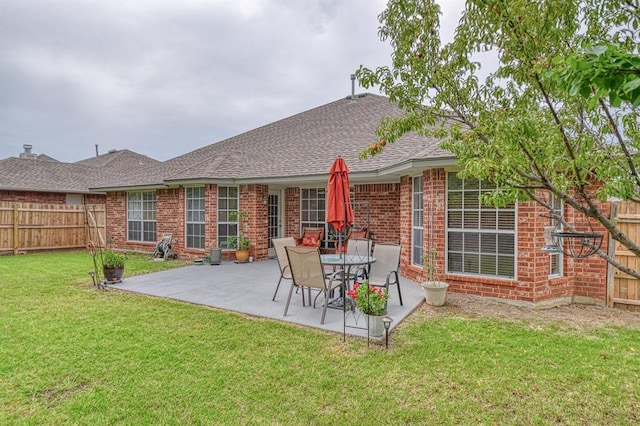 645 SW 160th St, Oklahoma City, OK 73170 - back of house with brick siding, a fenced backyard, a patio area, and roof with shingles