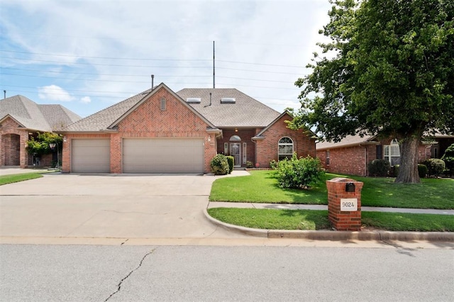 9024 NW 79th Ter, Yukon, OK 73099 - traditional-style house with brick siding, a garage, driveway, a front yard, and a shingled roof