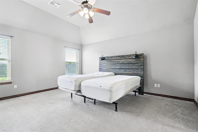 9024 NW 79th Ter, Yukon, OK 73099 - bedroom with multiple windows, carpet flooring, ceiling fan, and lofted ceiling