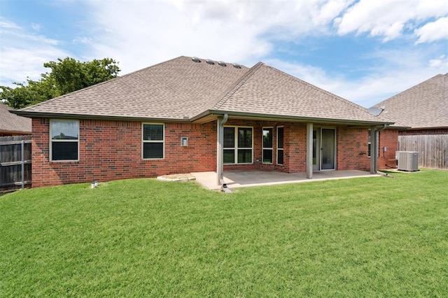 9024 NW 79th Ter, Yukon, OK 73099 - back of house with a shingled roof, brick siding, and a patio