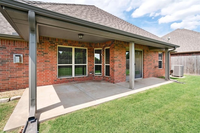 9024 NW 79th Ter, Yukon, OK 73099 - back of house with brick siding, roof with shingles, and a patio area