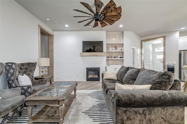 14812 Deerbrook Blvd, Oklahoma City, OK 73142 - living room with light wood-style floors, recessed lighting, a large fireplace, and a ceiling fan