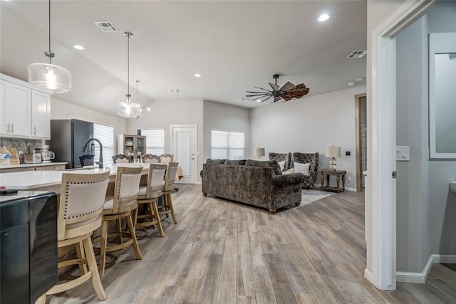 14812 Deerbrook Blvd, Oklahoma City, OK 73142 - living area featuring light wood-style flooring, ceiling fan, vaulted ceiling, and recessed lighting