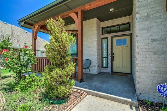14812 Deerbrook Blvd, Oklahoma City, OK 73142 - view of exterior entry featuring covered porch and brick siding