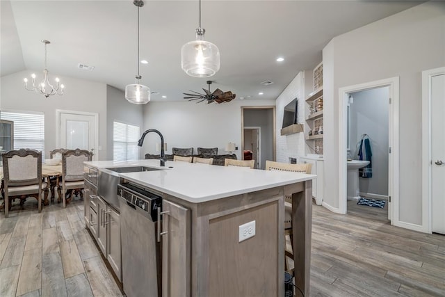 14812 Deerbrook Blvd, Oklahoma City, OK 73142 - kitchen with dishwasher, light wood-style floors, an island with sink, a kitchen bar, and lofted ceiling