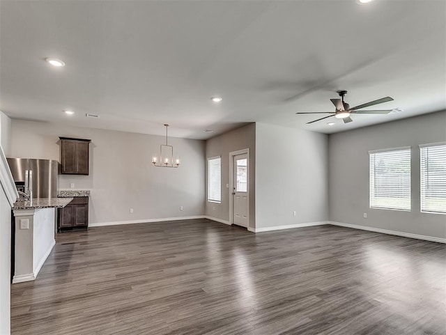 4205 Palmetto Bluff Dr, Mustang, OK 73064 - unfurnished living room with a chandelier, recessed lighting, a ceiling fan, and dark wood finished floors