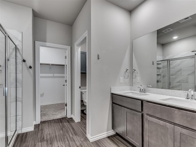 4205 Palmetto Bluff Dr, Mustang, OK 73064 - full bath with a shower stall, a spacious closet, wood finished floors, and double vanity