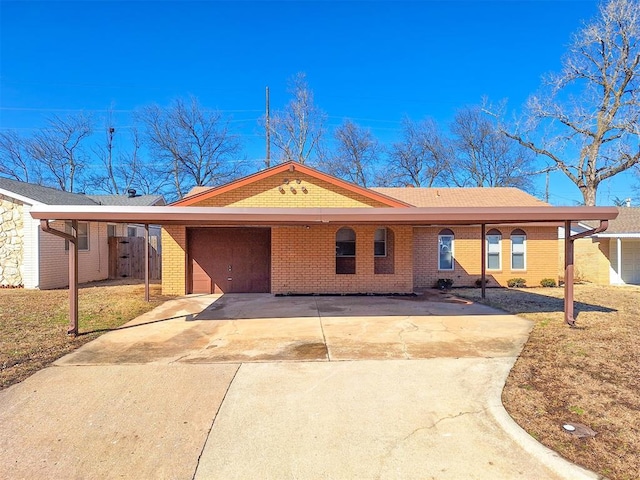 4713 Meench Dr, Del City, OK 73115 - view of front of house with brick siding, an attached garage, and concrete driveway