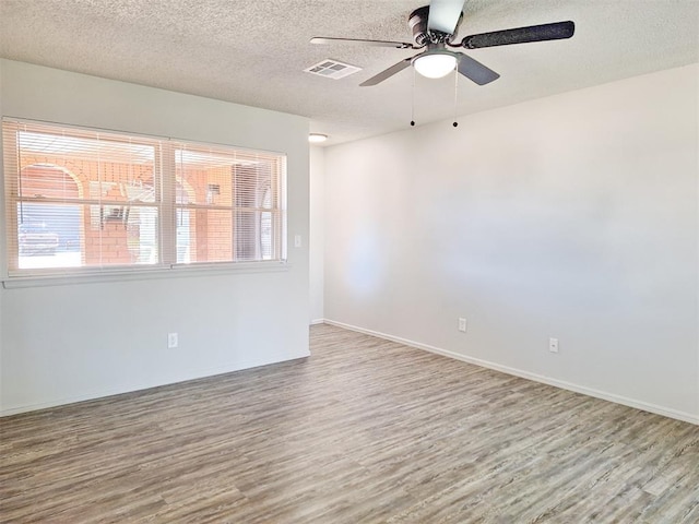 4713 Meench Dr, Del City, OK 73115 - empty room with wood finished floors, healthy amount of natural light, ceiling fan, and a textured ceiling