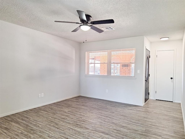 4713 Meench Dr, Del City, OK 73115 - empty room with wood finished floors, a textured ceiling, and a ceiling fan