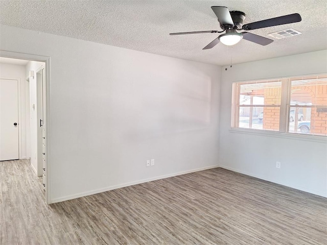 4713 Meench Dr, Del City, OK 73115 - spare room with light wood-type flooring, a textured ceiling, and ceiling fan