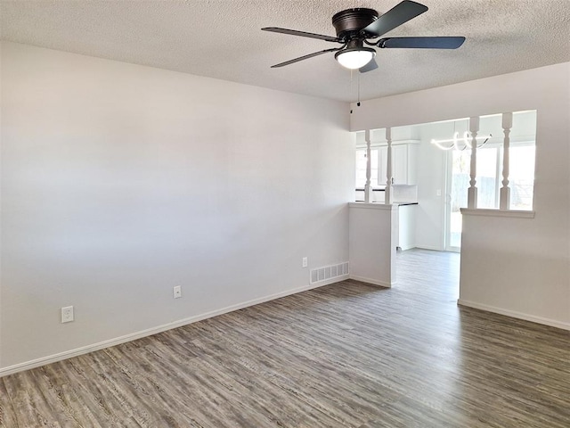 4713 Meench Dr, Del City, OK 73115 - unfurnished room with a ceiling fan, wood finished floors, and a textured ceiling