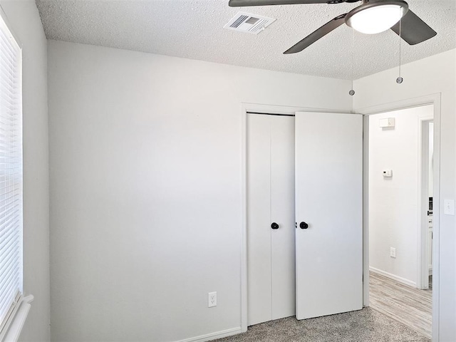 4713 Meench Dr, Del City, OK 73115 - unfurnished bedroom with a closet, a textured ceiling, and a ceiling fan