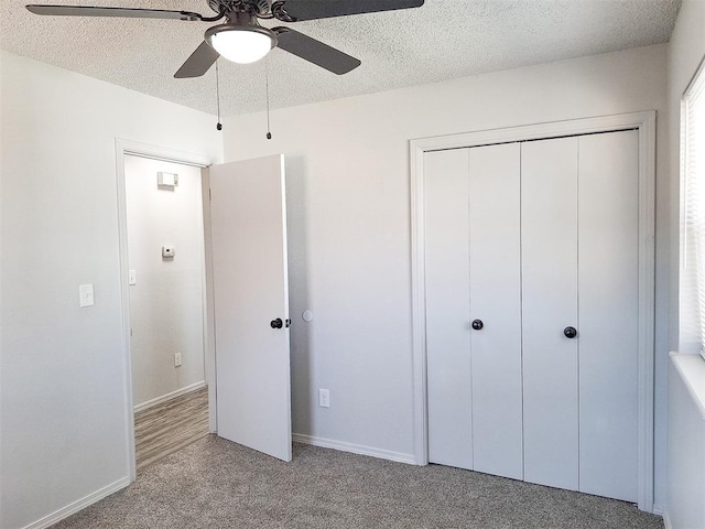 4713 Meench Dr, Del City, OK 73115 - unfurnished bedroom featuring carpet flooring, a closet, a textured ceiling, and a ceiling fan