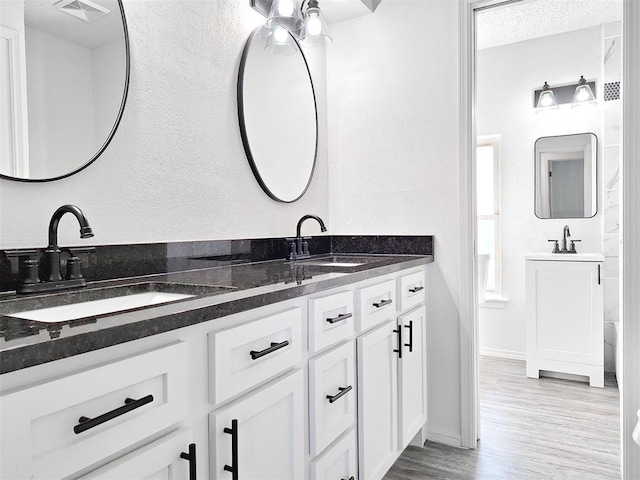 4713 Meench Dr, Del City, OK 73115 - full bathroom featuring double vanity and wood finished floors