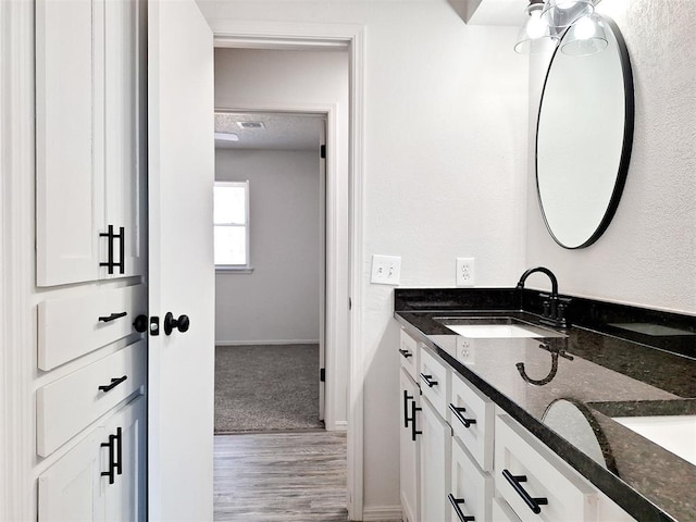 4713 Meench Dr, Del City, OK 73115 - bathroom with double vanity and wood finished floors