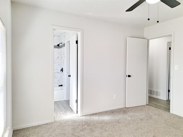 4713 Meench Dr, Del City, OK 73115 - unfurnished bedroom with carpet floors, ensuite bath, and ceiling fan