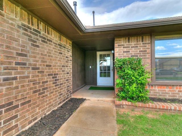 17 Pueblo, Edmond, OK 73013 - doorway to property featuring brick siding