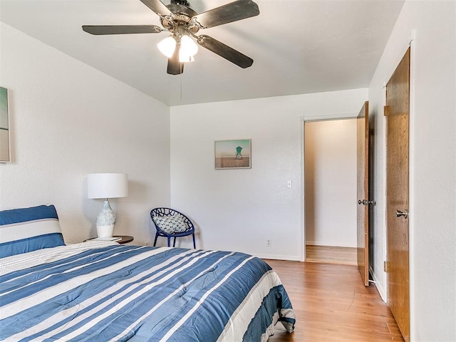 17 Pueblo, Edmond, OK 73013 - bedroom featuring wood finished floors and ceiling fan