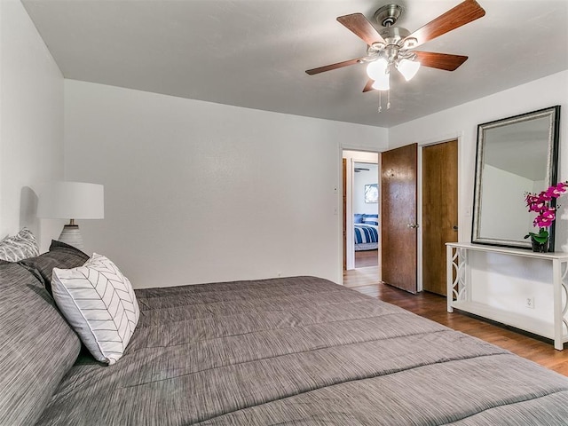 17 Pueblo, Edmond, OK 73013 - bedroom with wood finished floors and ceiling fan