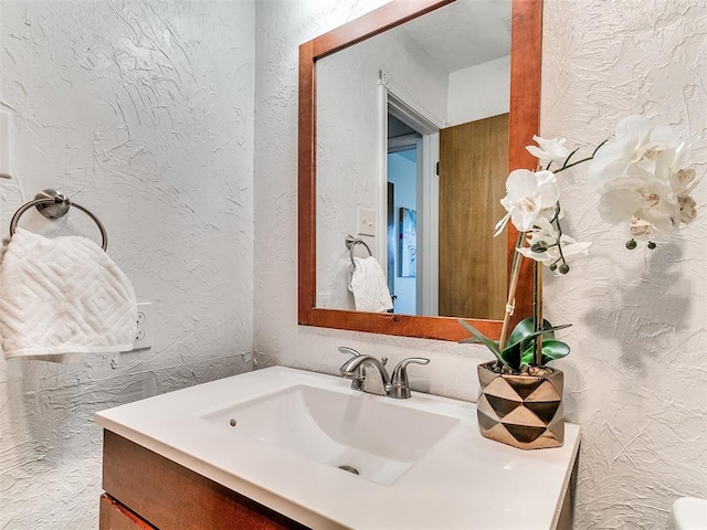 17 Pueblo, Edmond, OK 73013 - bathroom featuring vanity and a textured wall