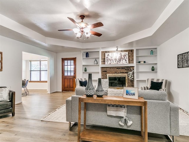 17 Pueblo, Edmond, OK 73013 - living area with ceiling fan, a fireplace, and wood finished floors