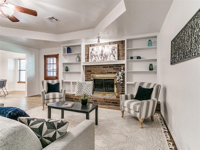 17 Pueblo, Edmond, OK 73013 - living area with a ceiling fan, wood finished floors, and a brick fireplace