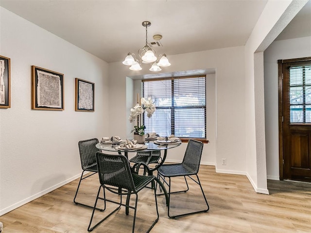 17 Pueblo, Edmond, OK 73013 - dining area with a chandelier and light wood-type flooring