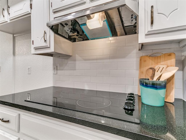 17 Pueblo, Edmond, OK 73013 - kitchen with range hood, black electric cooktop, white cabinetry, and tasteful backsplash