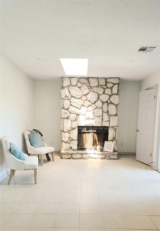 537 NW 114th St, Oklahoma City, OK 73114 - living area featuring a stone fireplace and baseboards